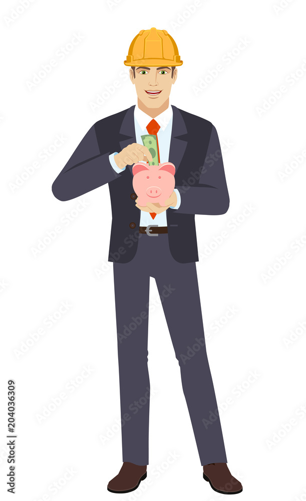 Businesswoman in construction helmet puts banknote in a piggy bank Businesswoman in construction helmet puts banknote in a piggy bank