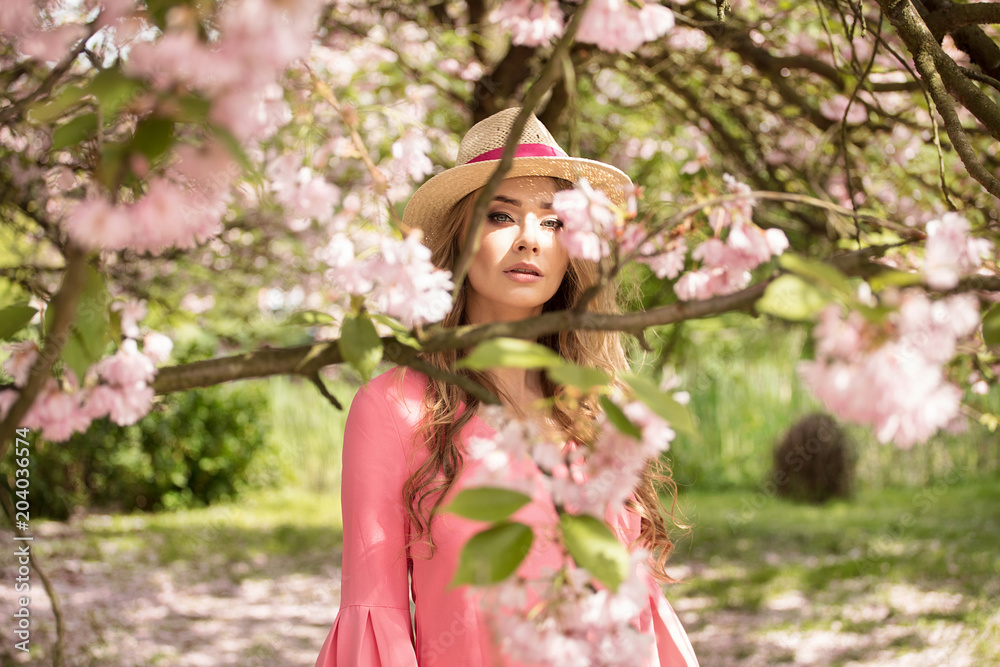 Attractive blonde girl in blooming garden. Attractive blonde girl in blooming garden.