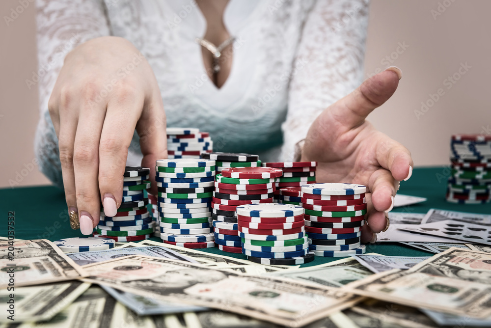 Pile of chips in female hands ready to make bet Pile of chips in female hands ready to make bet