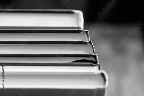 Close-up of a stack of books. Black and white photography.