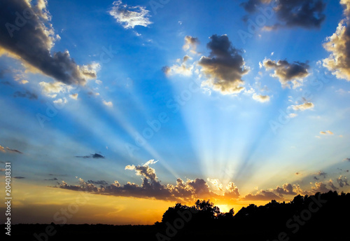 Kansas summer sunset with prominent God beams photo