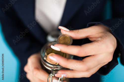 Woman holding a 2 Euro coin