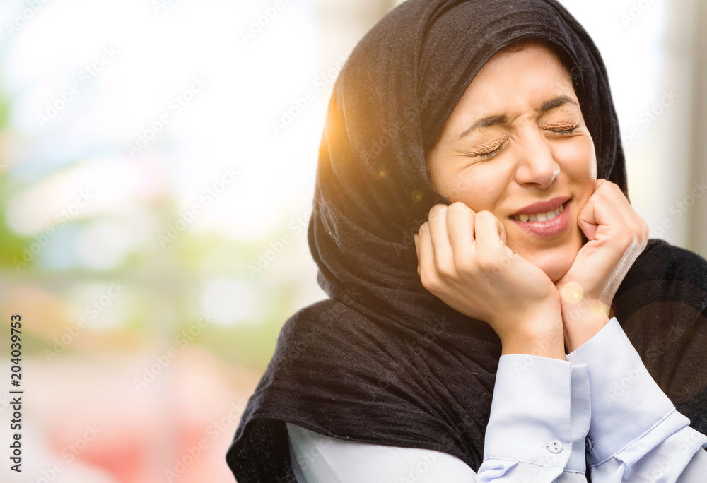 Young arab woman wearing hijab confident and happy with a big natural smile laughing Young arab woman wearing hijab confident and happy with a big natural smile laughing