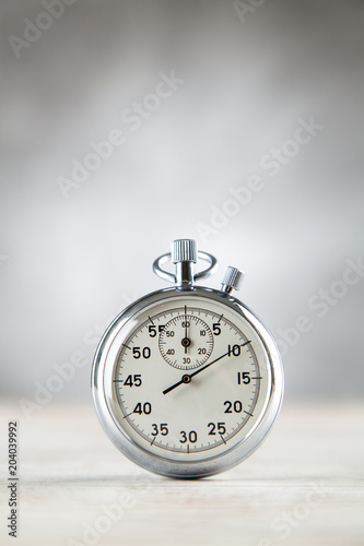 Analog stopwatch on grey background