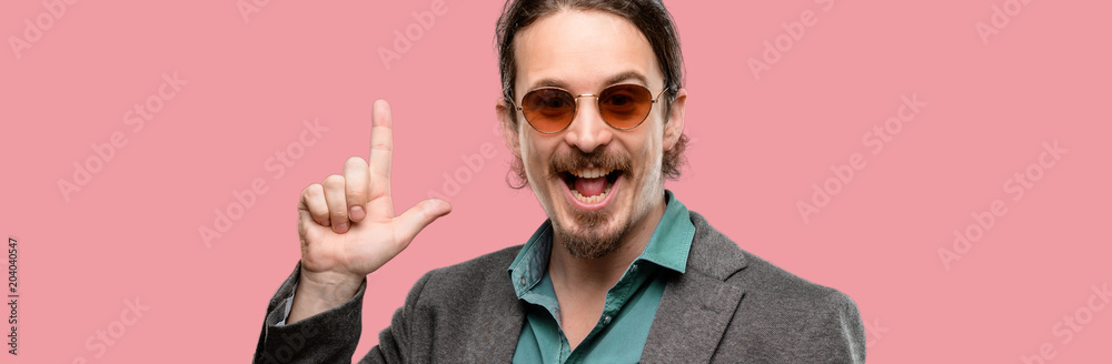 Handsome young man pointing away side with finger Handsome young man pointing away side with finger
