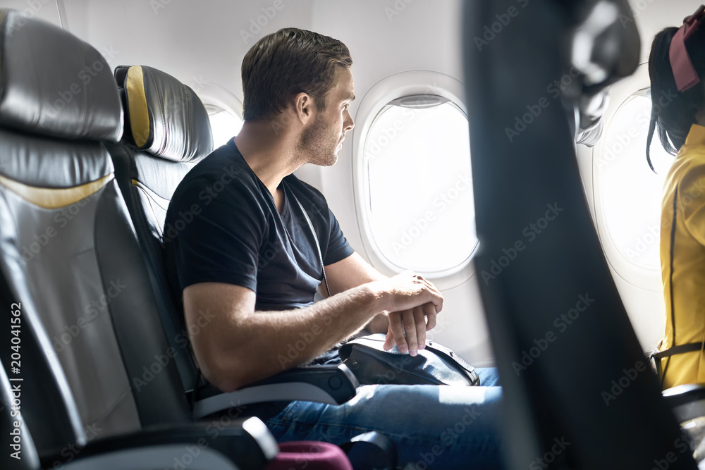 Fototapeta premium Handsome guy in airplane