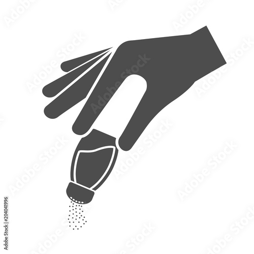Hand holding glass salt shaker with falling salt icon concept