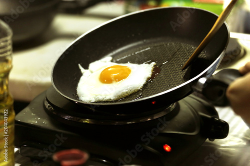 a fried egg in a flying pan © Praiwan Wasanruk