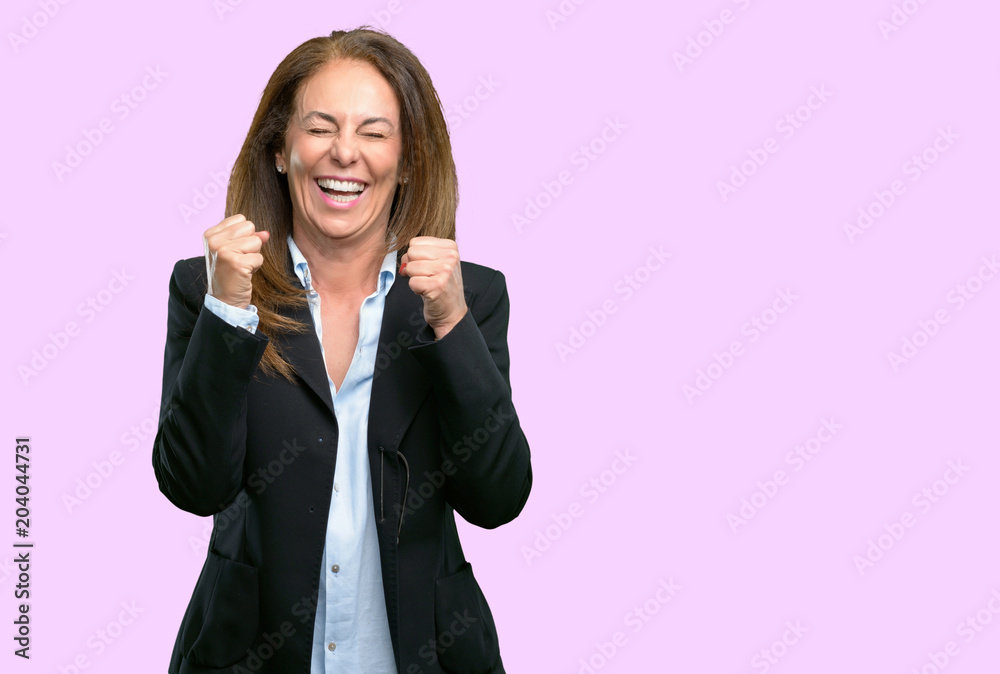 Middle age business woman happy and surprised cheering expressing wow gesture Middle age business woman happy and surprised cheering expressing wow gesture