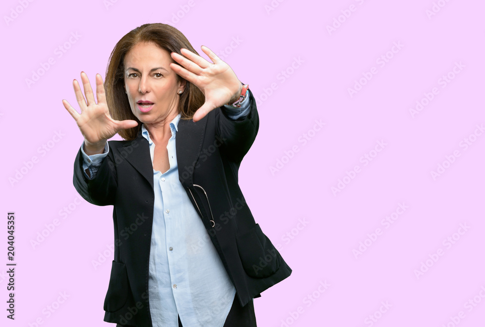 Middle age business woman confident and happy showing hands to camera, composing and framing gesture Middle age business woman confident and happy showing hands to camera, composing and framing gesture