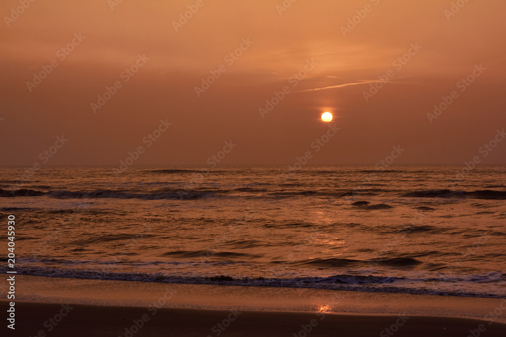 Sunset and reflection of the sun at the north sea, Netherlands