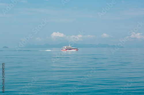 Fototapeta Naklejka Na Ścianę i Meble -  Blue sea surface with a ship on horizon