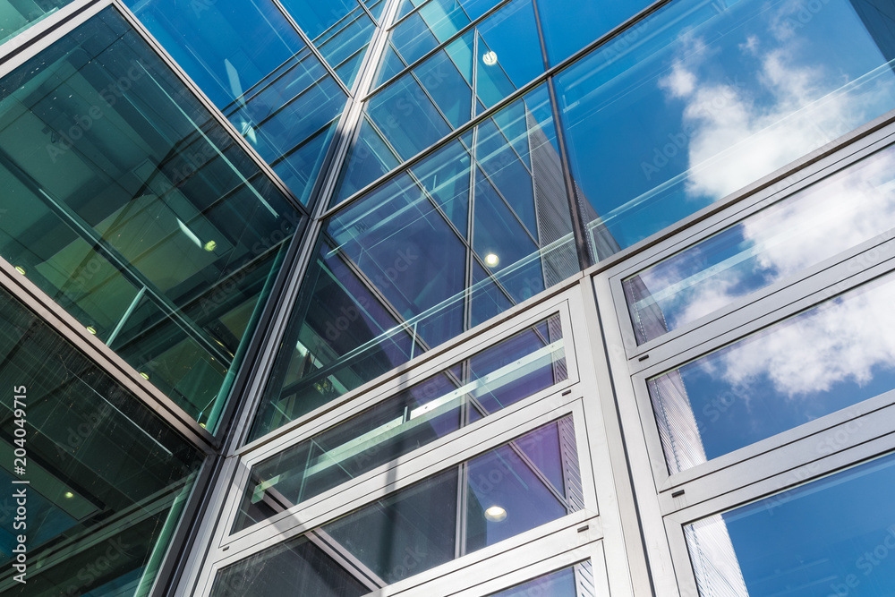 Obraz premium The glass architecture in city against a sky