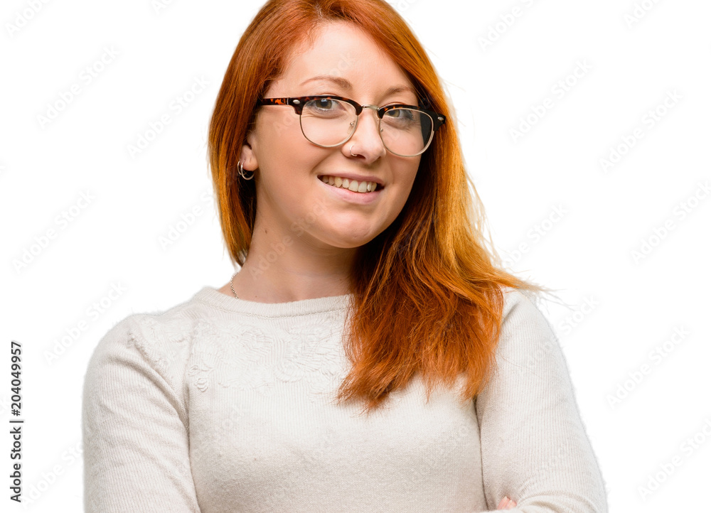 Beautiful young redhead woman with crossed arms confident and happy with a big natural smile laughing isolated over white background