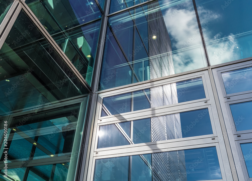 The glass architecture in city against a sky The glass architecture in city against a sky