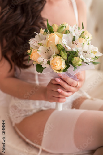 morning of the bride, the bride is holding a wedding bouquet