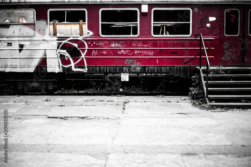 Abandoned tagged train at the old train station photo