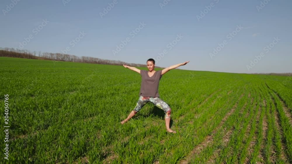 Girl on the lawn doing yoga slow-motion shooting Girl on the lawn doing yoga slow-motion shooting