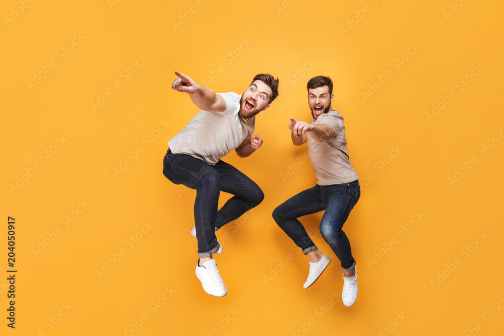 Two young excited men jumping together Two young excited men jumping together