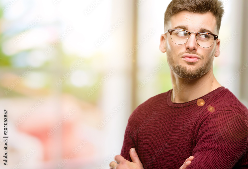 Handsome young man doubt expression, confuse and wonder concept, uncertain future Handsome young man doubt expression, confuse and wonder concept, uncertain future