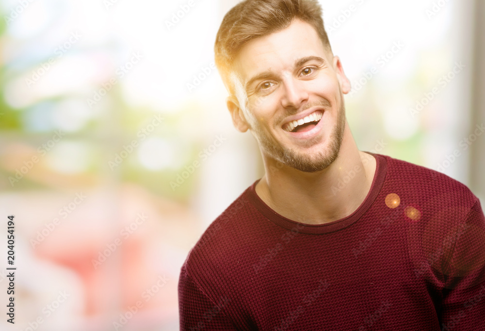 Handsome young man confident and happy with a big natural smile laughing Handsome young man confident and happy with a big natural smile laughing