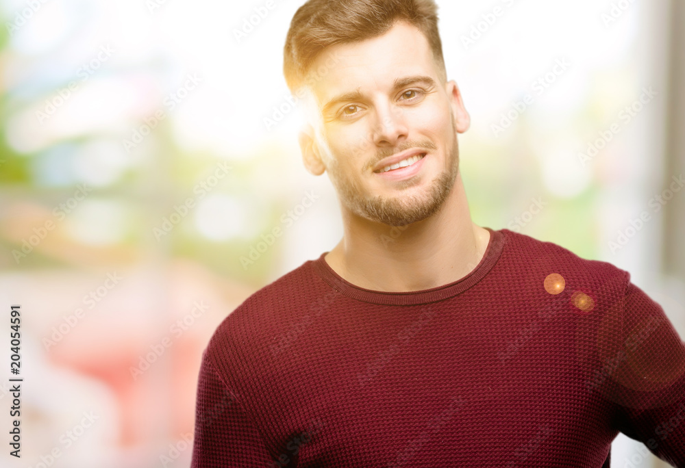 Handsome young man confident and happy with a big natural smile laughing Handsome young man confident and happy with a big natural smile laughing