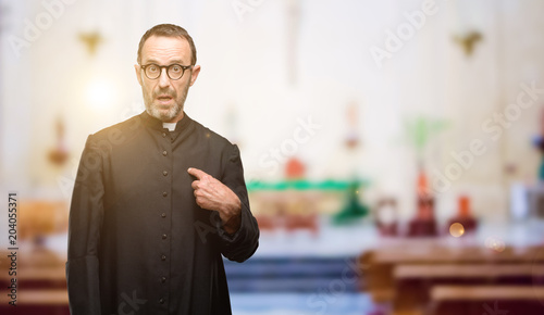 Quadro em tela Priest religion man happy and surprised cheering expressing wow gesture, pointin