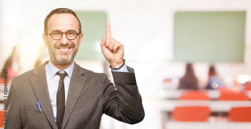 Teacher man using glasses raising finger, the number one at classroom Teacher man using glasses raising finger, the number one at classroom