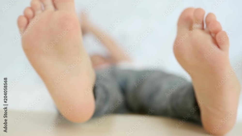 The legs of a child close-up on a white background The legs of a child close-up on a white background