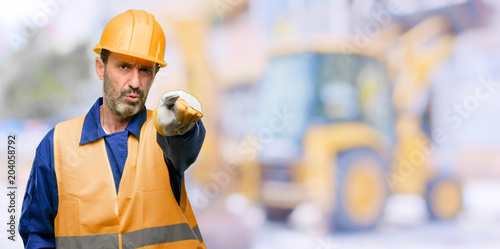 Senior engineer man, construction worker pointing to the front with finger at work