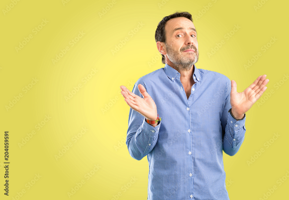 Handsome middle age man doubt expression, confuse and wonder concept, uncertain future Handsome middle age man doubt expression, confuse and wonder concept, uncertain future