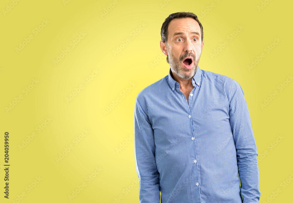 Handsome middle age man happy and surprised cheering expressing wow gesture Handsome middle age man happy and surprised cheering expressing wow gesture