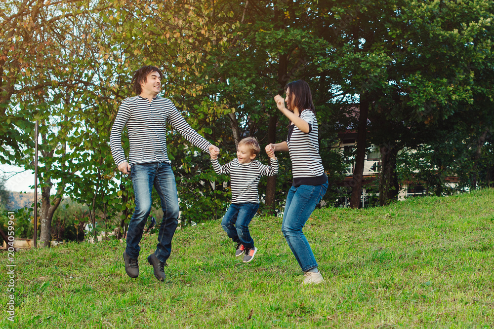 Fototapeta premium happy young family spending time together in park