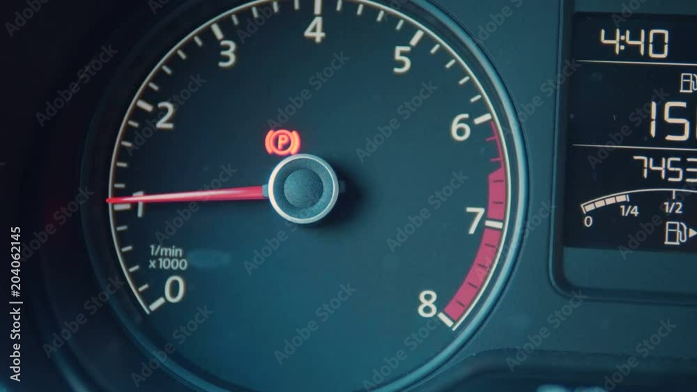 Car interior dashboard details with indication lamps. Car detailing. Car instrument panel. Dashboard closeup with visible speedometer and fuel level Car interior dashboard details with indication lamps. Car detailing. Car instrument panel. Dashboard closeup with visible speedometer and fuel level