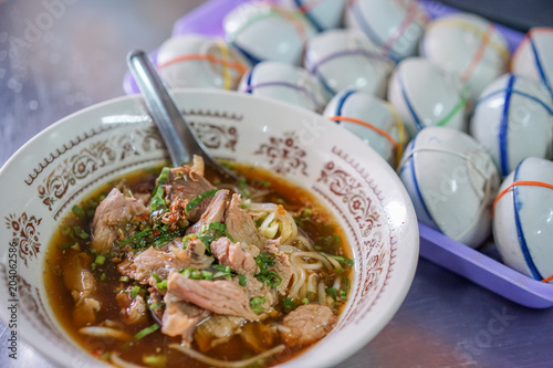 Rice noodle soup with Stewed pork and Khanom Thuai (Thai dessert) ready to eat. photo