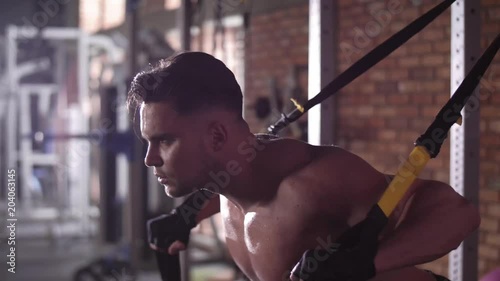 Muscular man exercising at gym photo