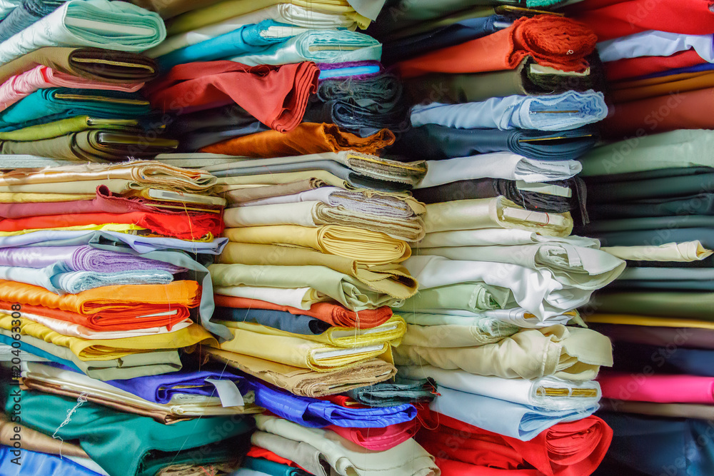 Multicolor fabric rolls stacked. Multicolor fabric rolls stacked.
