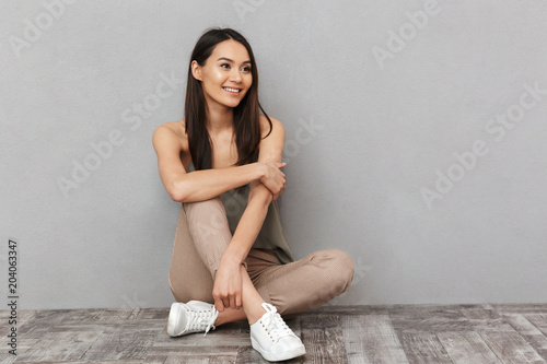 Portrait of a pretty asian woman sitting on a floor