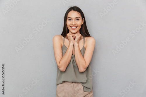 Portrait of an excited asian woman looking at camera