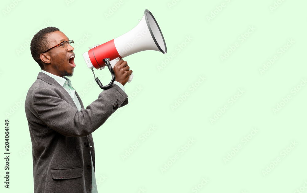 African black man wearing jacket communicates shouting loud holding a megaphone, expressing success and positive concept, idea for marketing or sales African black man wearing jacket communicates shouting loud holding a megaphone, expressing success and positive concept, idea for marketing or sales