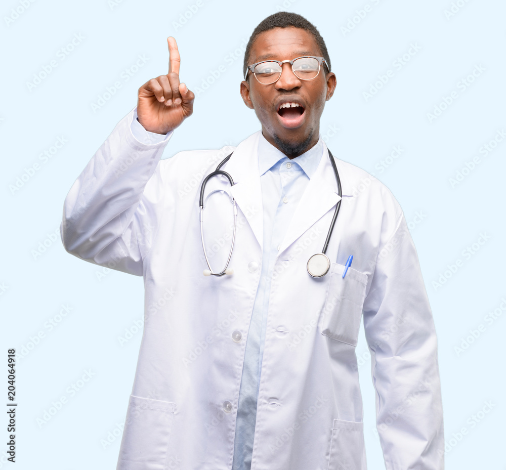 Young black doctor, medical professional pointing away side with finger