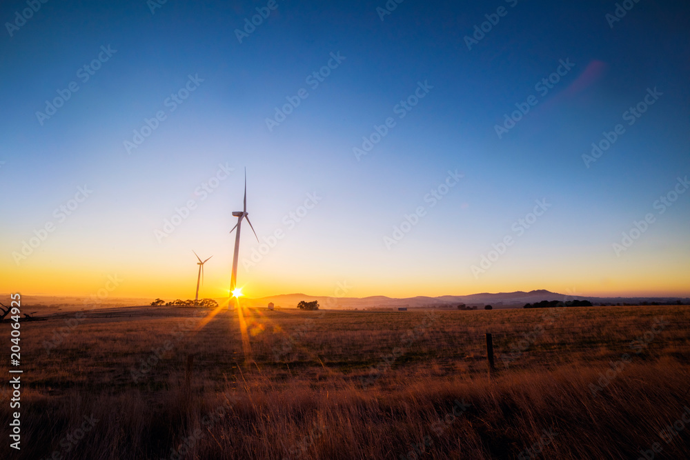 Obraz premium wind turbines with the sun rising