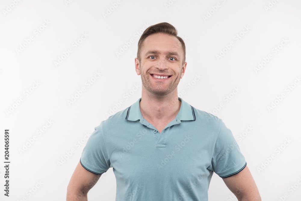 Joyful mood. Cheerful happy man smiling while looking at you Joyful mood. Cheerful happy man smiling while looking at you