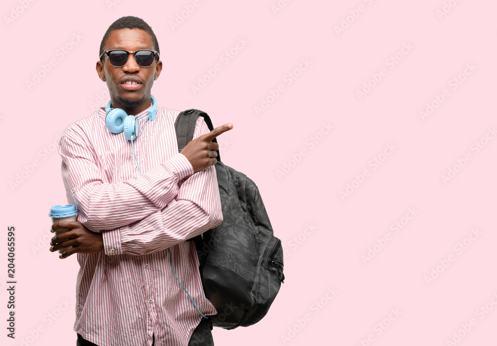 African black man student pointing away side with finger African black man student pointing away side with finger