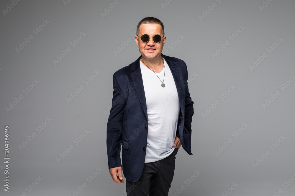 Senior businessman in eyesglasses isolated on gray background Senior businessman in eyesglasses isolated on gray background