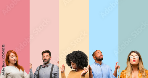 Cool group of people, woman and man doing ok sign gesture with both hands expressing meditation and relaxation