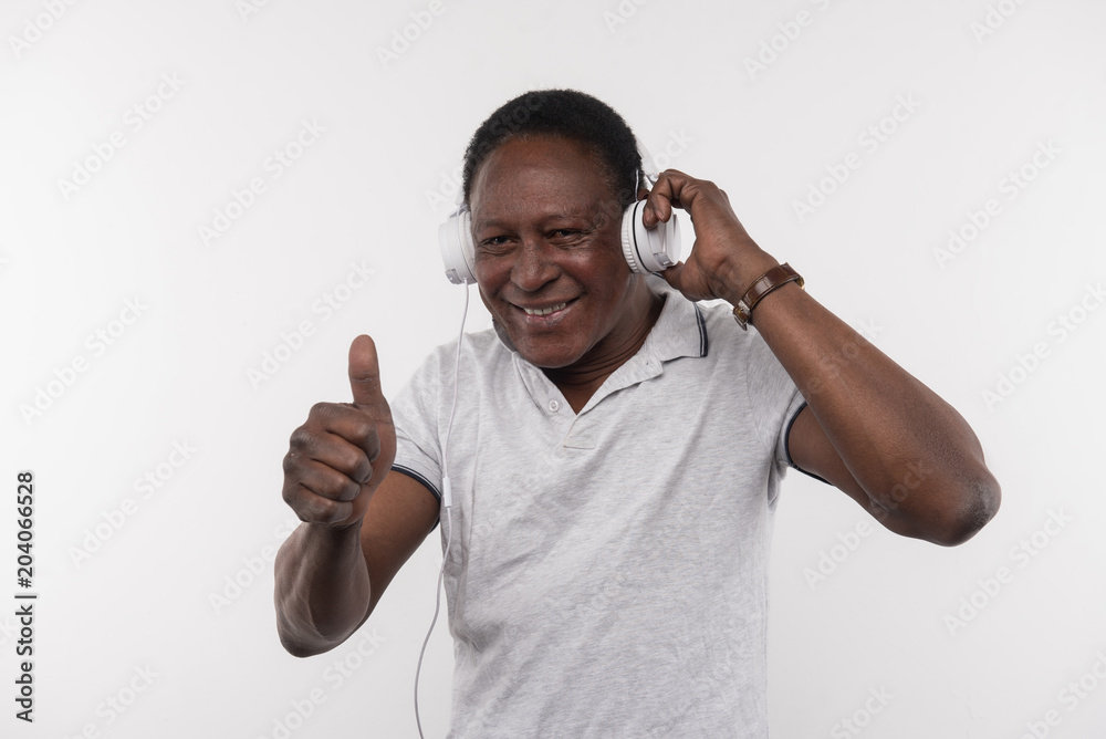 Great music. Joyful happy man showing OK gesture while enjoying the music Great music. Joyful happy man showing OK gesture while enjoying the music