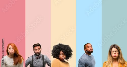 Cool group of people, woman and man puffing out cheeks, having fun making funny face
