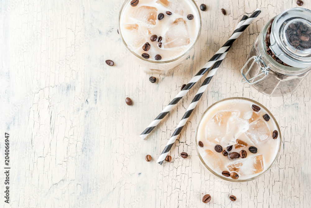 Summer cold Iced coffee frappe with milk and ice cubes, light concrete background copy space top view Summer cold Iced coffee frappe with milk and ice cubes, light concrete background copy space top view