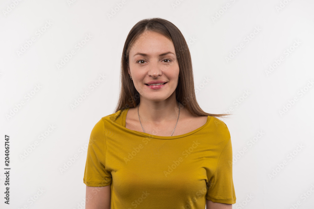 Pretty woman. Pleasant beautiful woman looking at you while standing against white background Pretty woman. Pleasant beautiful woman looking at you while standing against white background